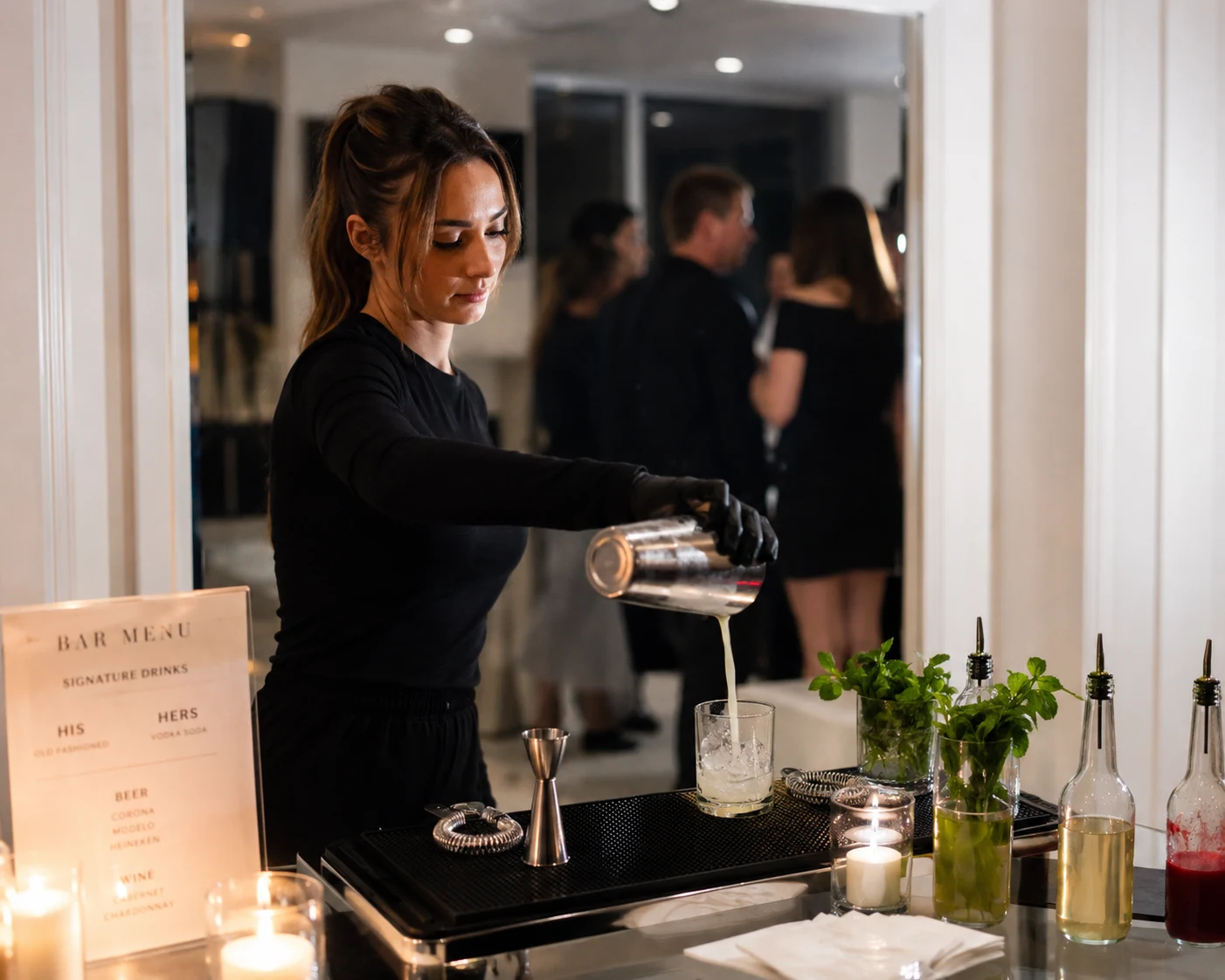 Cocktail inspiration: an elegantly styled bar with fresh mint, candles and a bartender pouring a drink